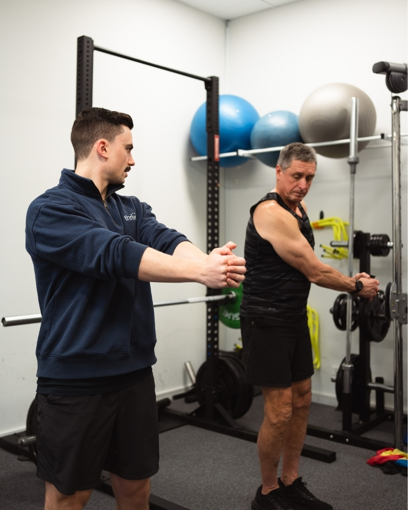 GLAD back accredited physio teach as GLAD back program participant to perform a core strengthening exercise